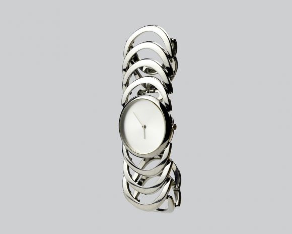 Watches And Jewelry Woman - a white clock sitting on top of a metal bracelet