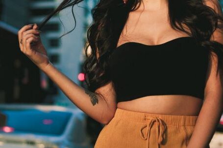 Stylish Accessories - Woman Wearing Black Crop Top and Orange Skirt Standing