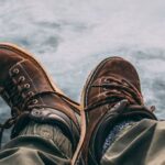 Adventure Footwear - Person Sitting on Rock Near Waterfalls