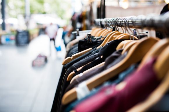 Glam Clothes - selective focus photography of hanged clothes