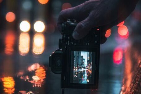 Day-to-night Transition - Person Holding Black Dslr Camera Taking Photo of City Lights during Night Time