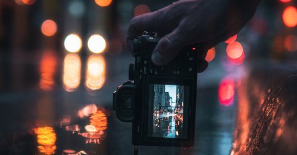 Day-to-night Transition - Person Holding Black Dslr Camera Taking Photo of City Lights during Night Time