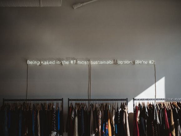 Sustainable Fashion - assorted clothes lot on gray clothes racks