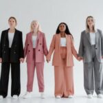 Accessorize Outfits - Women in Blazer and Pants Standing while Holding Hands