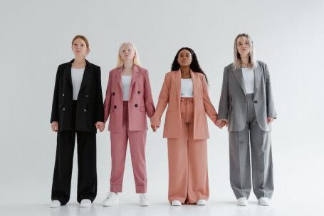 Accessorize Outfits - Women in Blazer and Pants Standing while Holding Hands