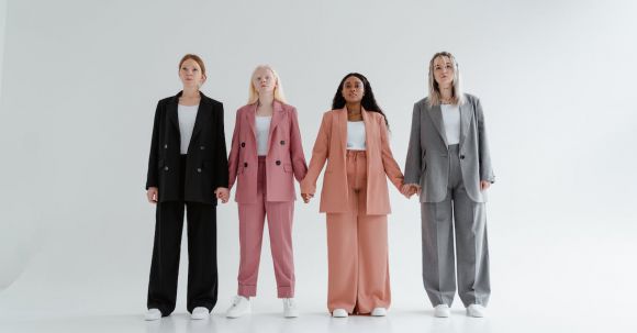 Accessorize Outfits - Women in Blazer and Pants Standing while Holding Hands